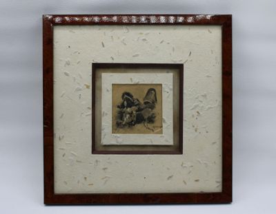 tableau représentant un oiseau dans un cadre, sur fond blanc