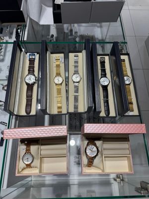 a glass display case with several watches on it