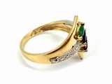 a close up of a gold ring with a green and white stone