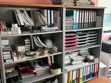 a desk with a bunch of files on it in a room