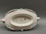 a white bowl with pink and green flowers on it