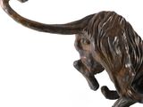 statue of a lion on a marble base on a white background