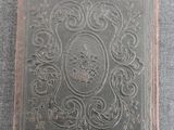 an old book sitting on top of a gray surface