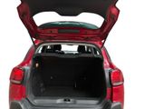 the back of a red car with its trunk open on a white background