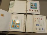 four open books with stamps on them sitting on a table
