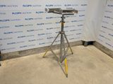 an image of a camera on a tripod in front of a wall