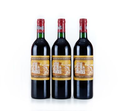 trois bouteilles de vin rouge posées l'une à côté de l'autre sur une surface blanche