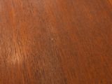 a close up of a wooden table with a clock on it