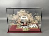 a miniature model of a house in a glass case