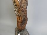 a statue of a man holding a bird on a pedestal