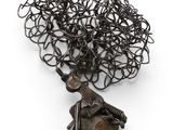 an image of a sculpture of a man with a tree on his head