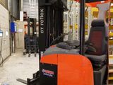 a fork lift truck that is parked in a warehouse