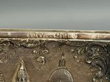 a silver box with a picture of a city on it