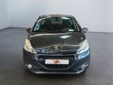 the front view of a grey car in a room with a white wall