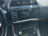 a car dashboard with a phone in it and a car key hanging from the dashboard