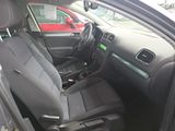 the interior of a car with black seats and a red car in the background