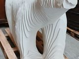 concrete sculpture of a polar bear on a pallet in a workshop