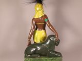 statue of a woman sitting on top of a statue of a lion