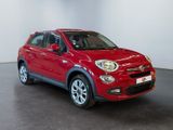 the red fiat suv is parked in a large room