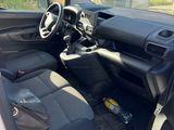 the interior of a car with the door open and the driver ' s seat down