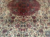 an antique persian rug with a large medallion design on the center