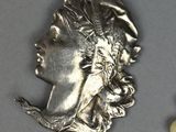 a picture of a necklace with a face of a woman on it