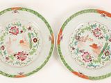 pair of chinese plates decorated with flowers and birds on them