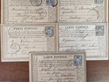 four old postcards are sitting on a wooden table