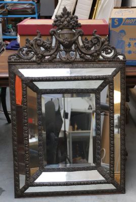 a mirror that is sitting on the floor in front of a table