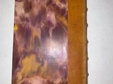 a brown and purple book on a white table