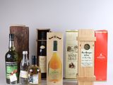 several bottles of alcohol are lined up on a white surface
