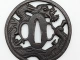 a close up of a metal plate with a dragon on it
