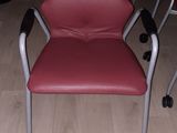 a red chair sitting on the floor in a room