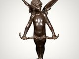 a bronze statue of an angel holding a piece of wood