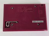 an image of a red electronic device on a white surface