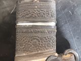 a silver vase that is sitting on a table