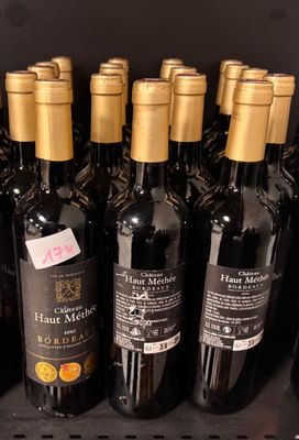 many bottles of wine sitting on a shelf in a store