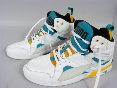 pair of white sneakers with blue and yellow accents on a white surface
