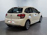 the rear end of a white citrole parked in a room
