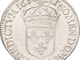 a close up of a silver coin with a crown on it