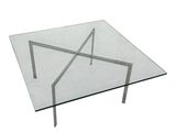 rectangular glass coffee table with metal legs and a clear glass top