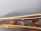 a close up of a gold bracelet with a diamond on it
