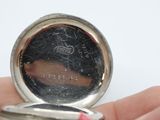 a person holding a pocket watch in their hand