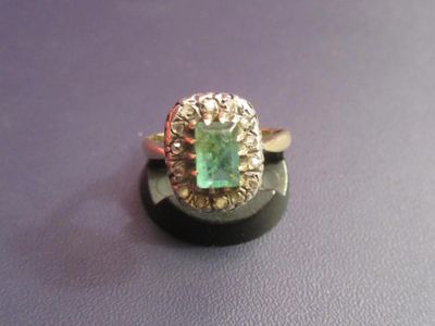 an image of a ring with a green stone in it