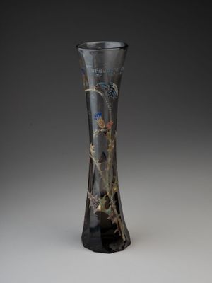 a glass vase with a design on it on a gray background