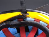 a close up of a yellow and blue bike with a red wheel