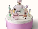 a bottle of chanel perfume on top of a pink box
