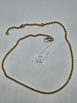 a close up of a gold chain with a tag on it