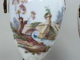 two vases that have been painted with a bridge in the background