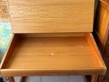 an image of a wooden desk with a drawer underneath it